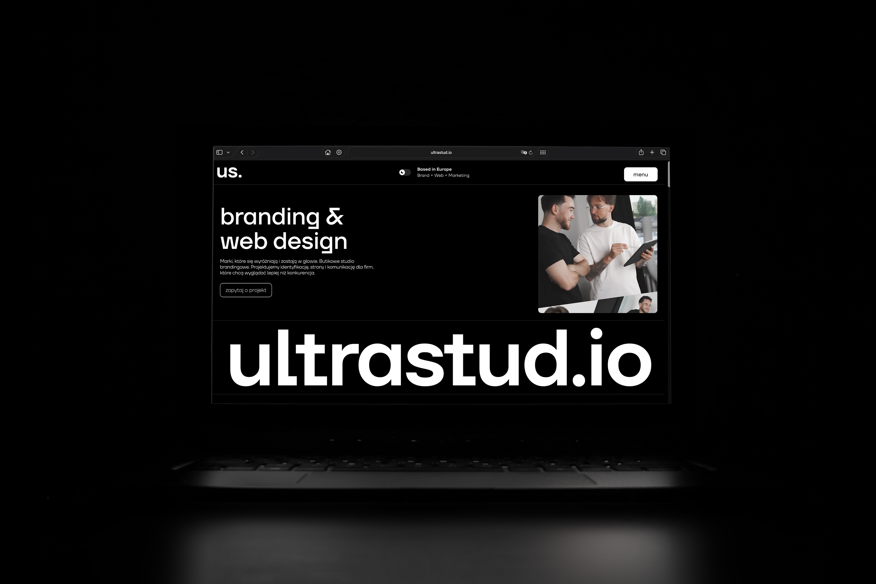 A laptop on a black background showing the ultrastud.io homepage: the “us.” logo, the headline “branding & web design”, and a large ultrastud.io wordmark below.